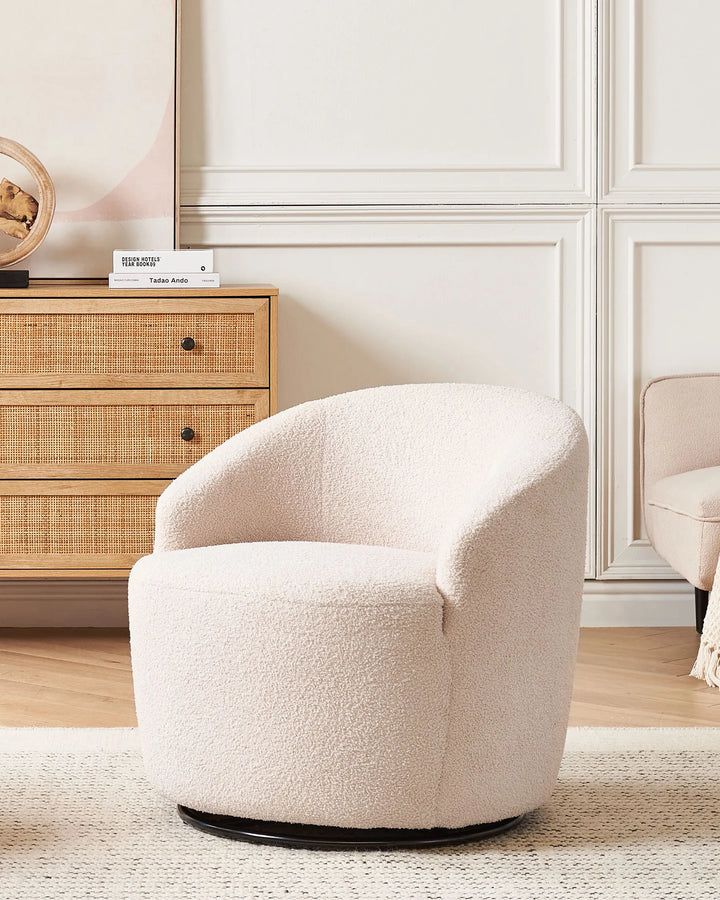 White swivel chair in a room with a wooden cabinet and decorative items.