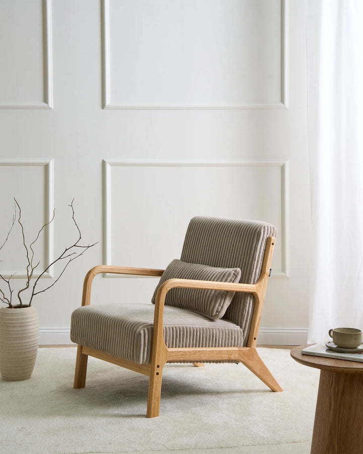 Modern armchair in a minimalistic room with a white wall and a small table.