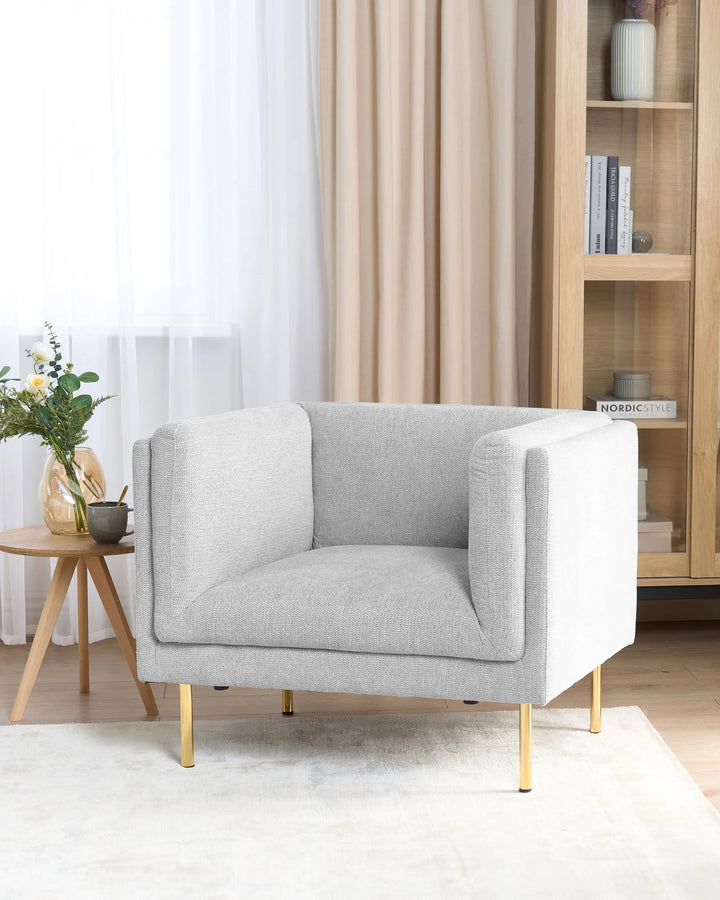 Gray armchair with gold legs in a living room setting