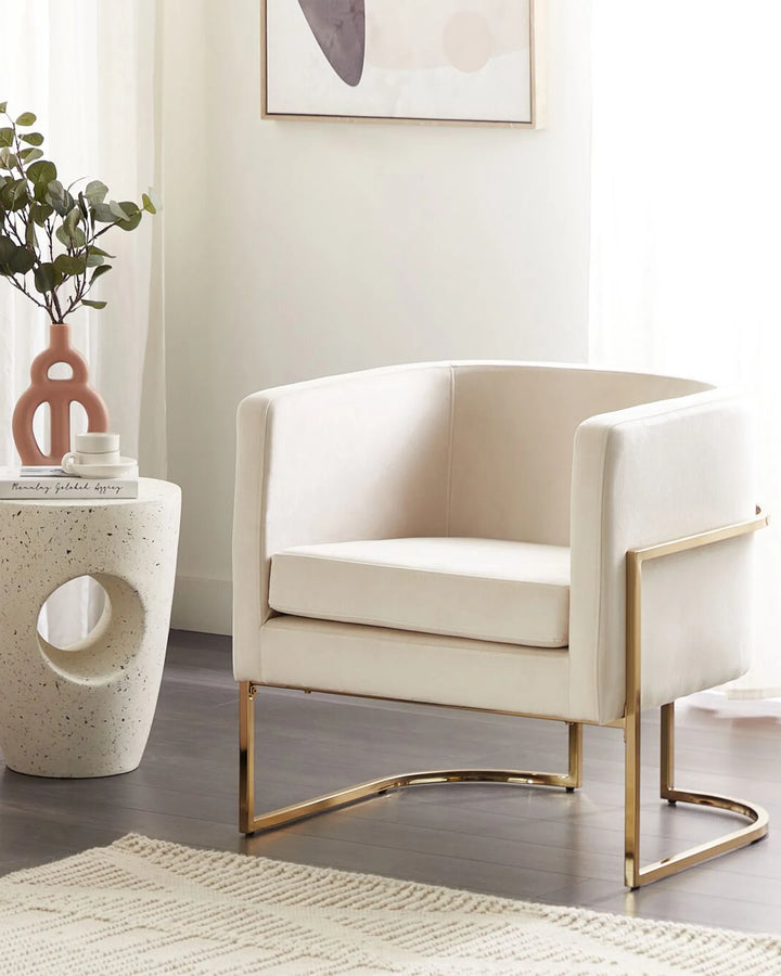 Beige armchair with gold legs in a modern living room setting