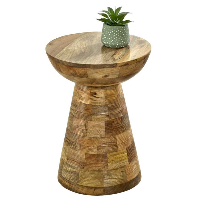 A mushroom-shaped solid wood round side table with a lacquered finish, displayed with a green plant on top.