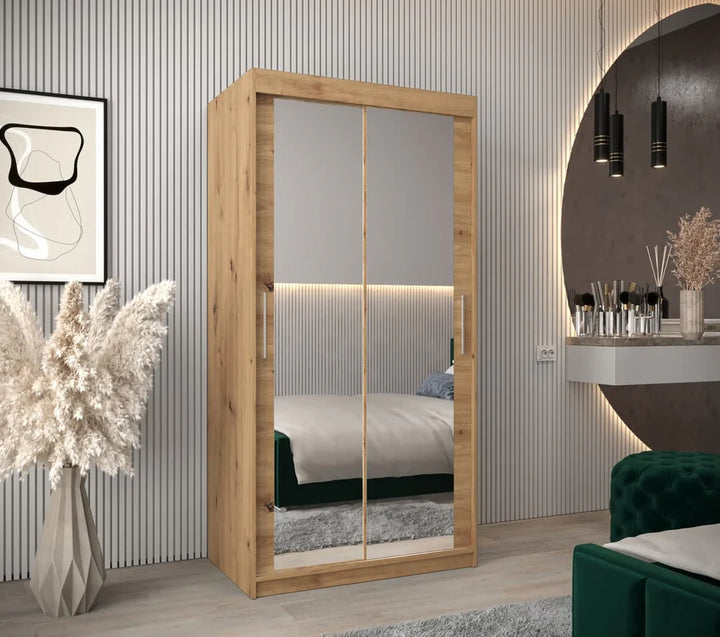 Wooden wardrobe with mirror doors in a room setting with decor elements.