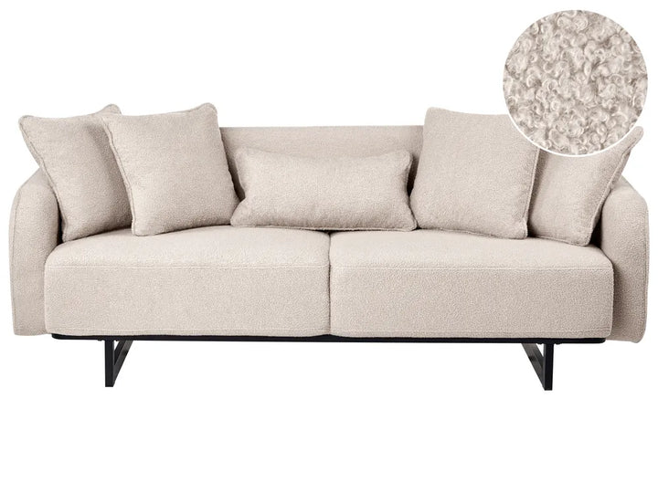 A light beige upholstered loveseat with five matching throw pillows and black metal legs, shown on a white background with a circular fabric close-up inset in the top right.