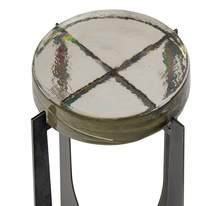 Round stool with a textured ceramic top and metal legs on a white background