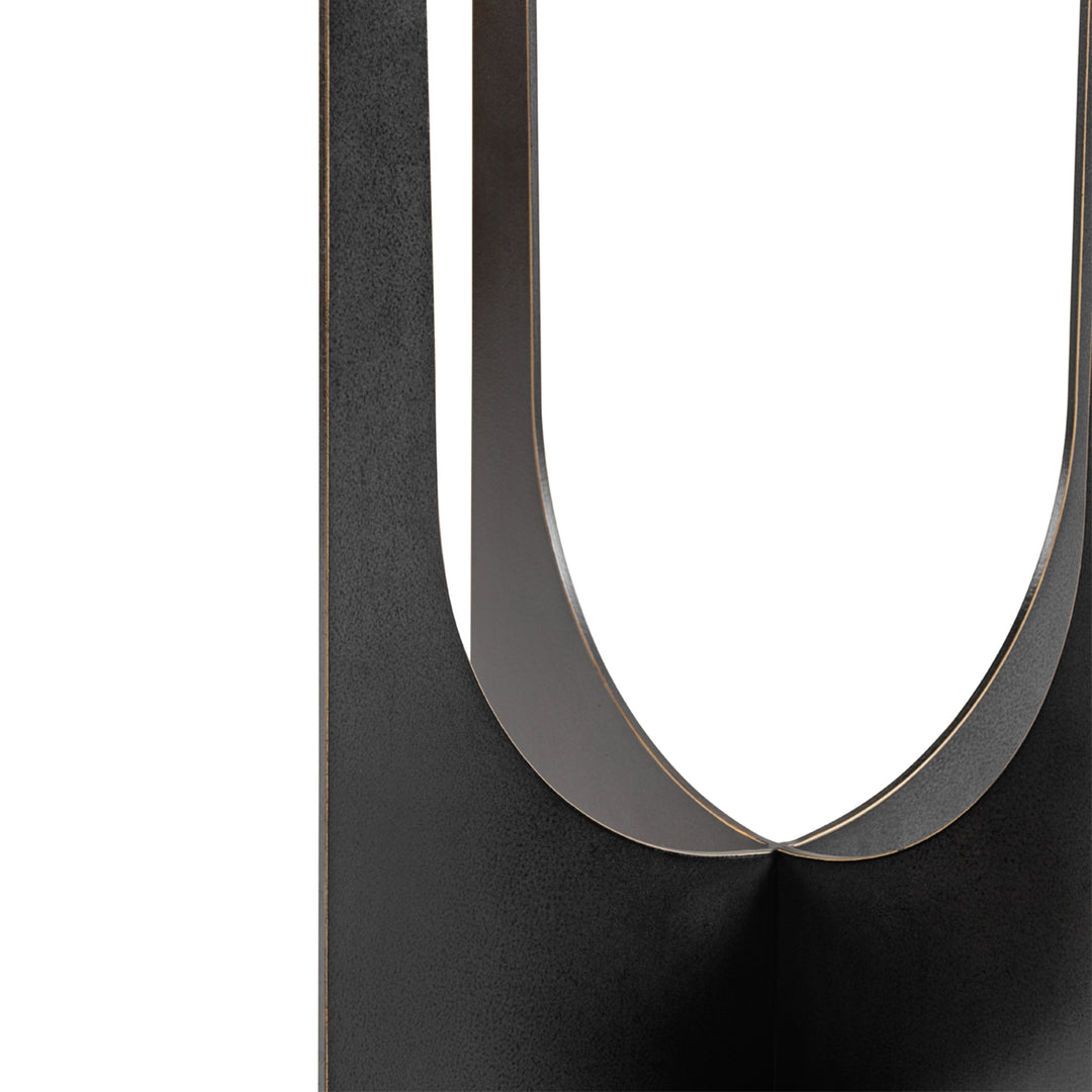 Close-up of a black metal stand with a U-shaped design on a white background