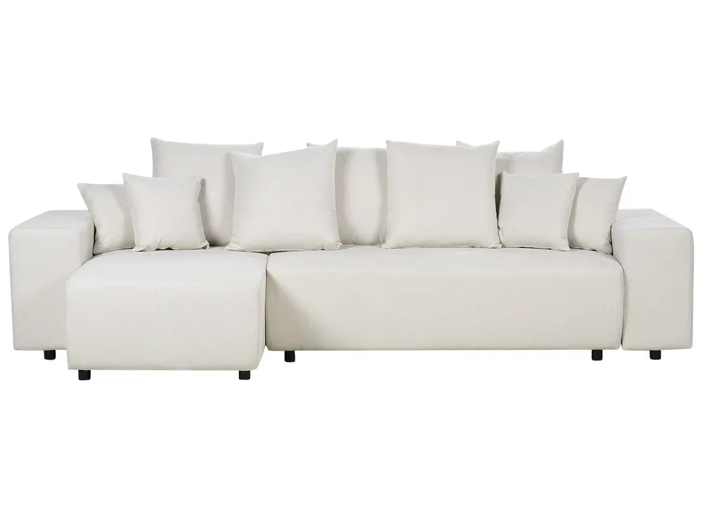 White sectional sofa with multiple cushions on a white background