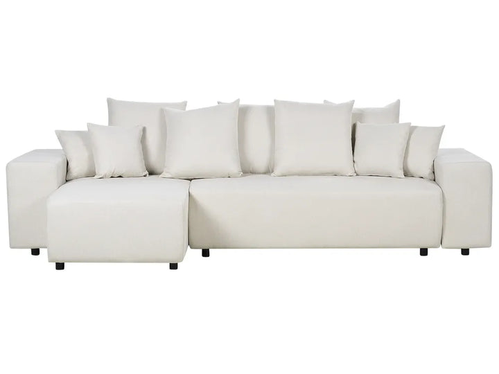 White sectional sofa with multiple cushions on a white background
