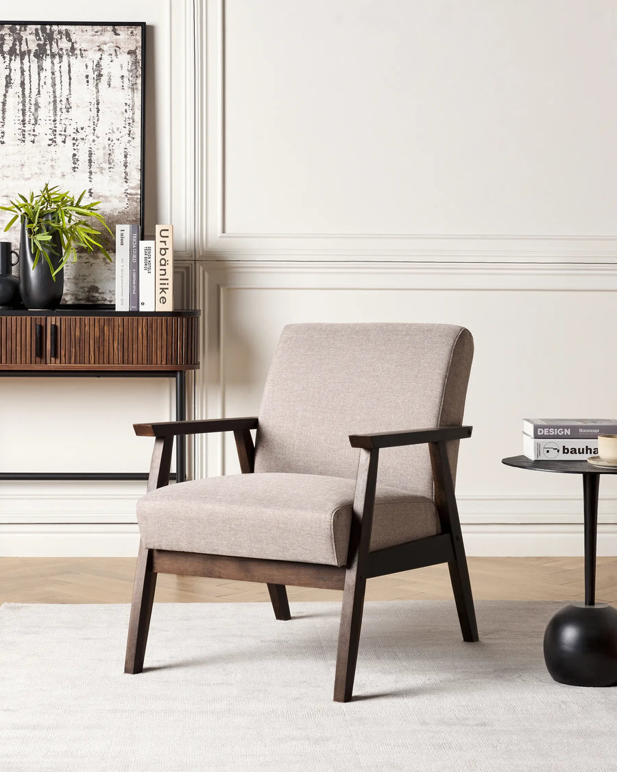 Beige armchair with wooden frame in a living room setting