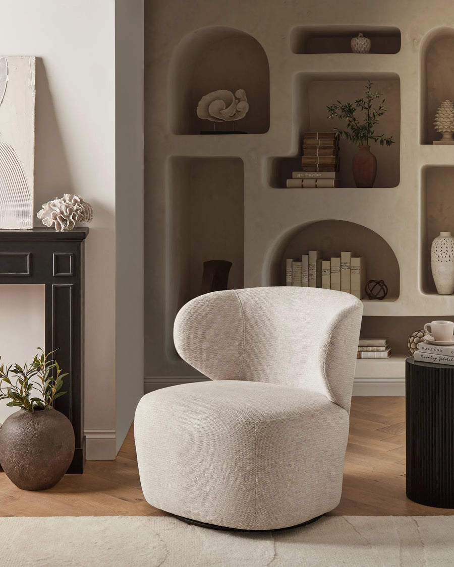 Beige armchair in a stylish room with shelves and decor
