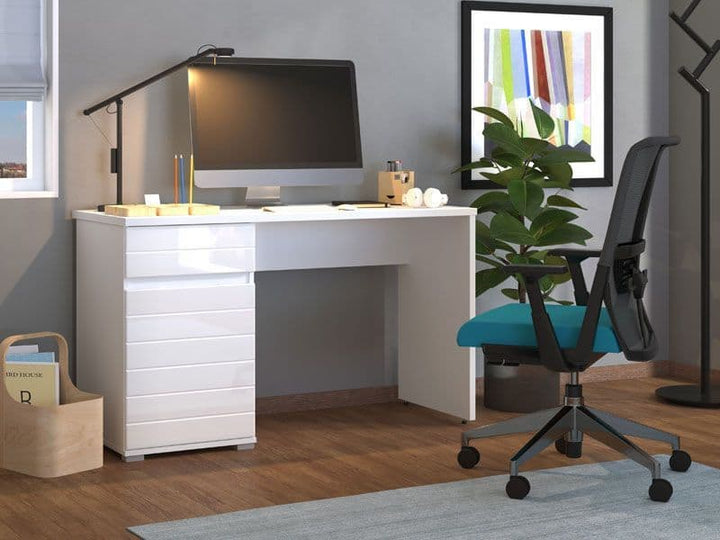 White desk with computer setup in a home office setting