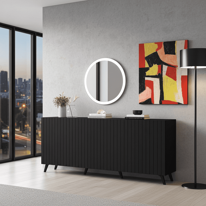 Modern interior with a black sideboard, round mirror, and abstract painting.