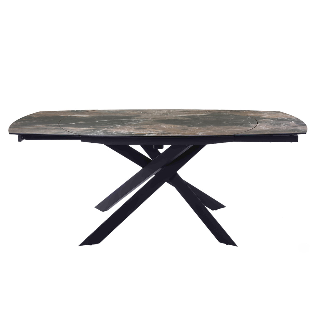 A rectangular outdoor dining table with a weathered gray-brown stone-look top and a black metal X-frame base, shown against a plain white background.