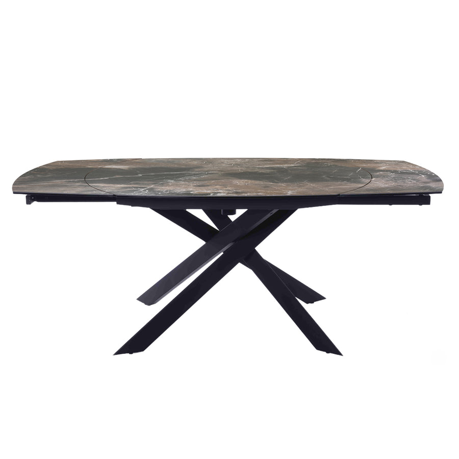 A rectangular outdoor dining table with a weathered gray-brown stone-look top and a black metal X-frame base, shown against a plain white background.