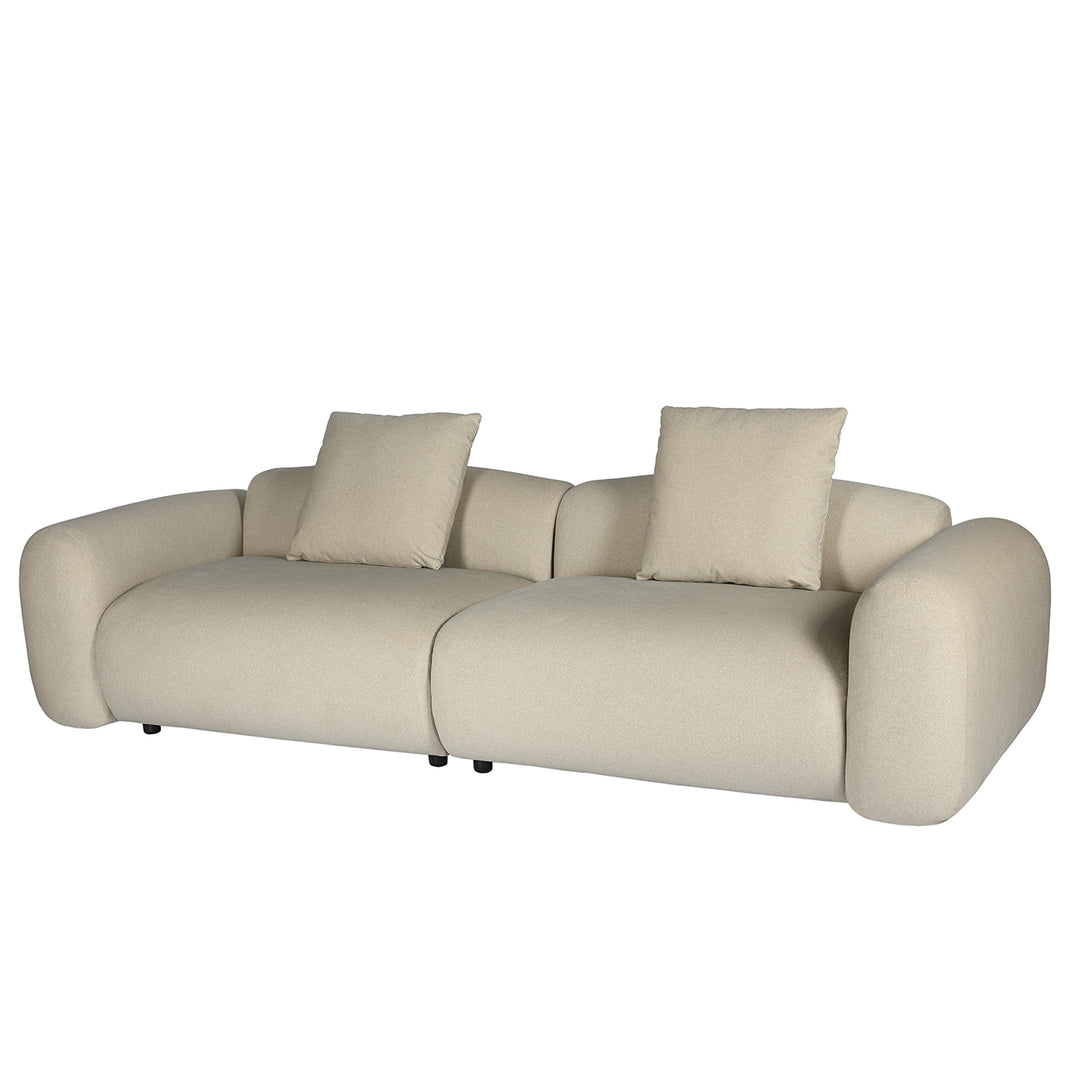 Beige sofa with two cushions on a white background