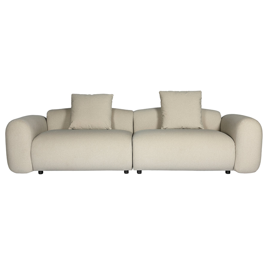 Beige sofa with three cushions on a white background