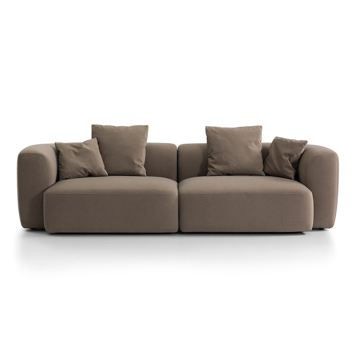 Brown sofa with four cushions on a white background