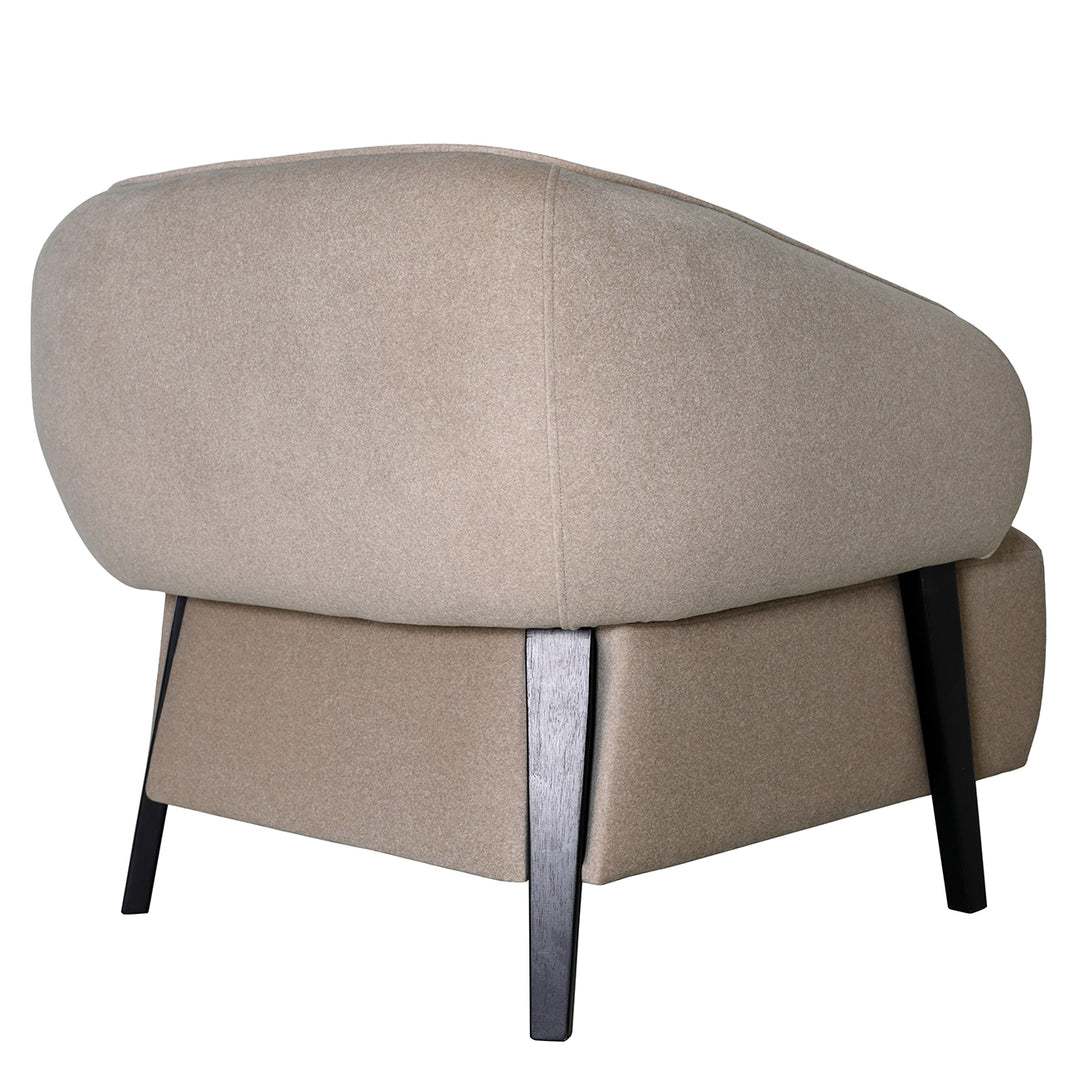 Beige ottoman with dark wooden legs on a white background