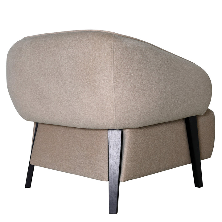 Beige ottoman with dark wooden legs on a white background