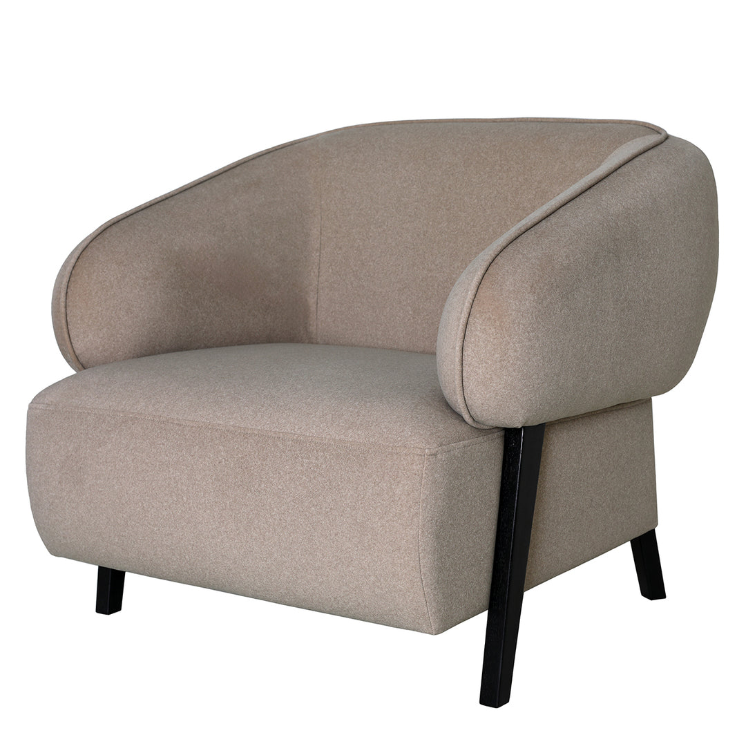 Beige armchair with black legs on a white background