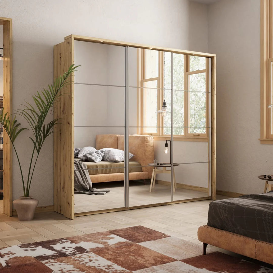Modern bedroom with a large wooden wardrobe with glass doors, a bed, and a plant.