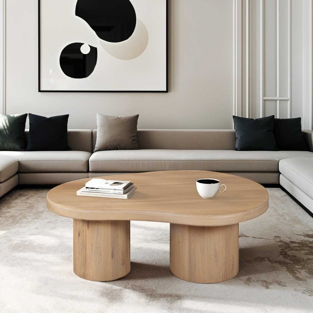 Modern living room with a wooden coffee table, sofa, and abstract art on the wall.