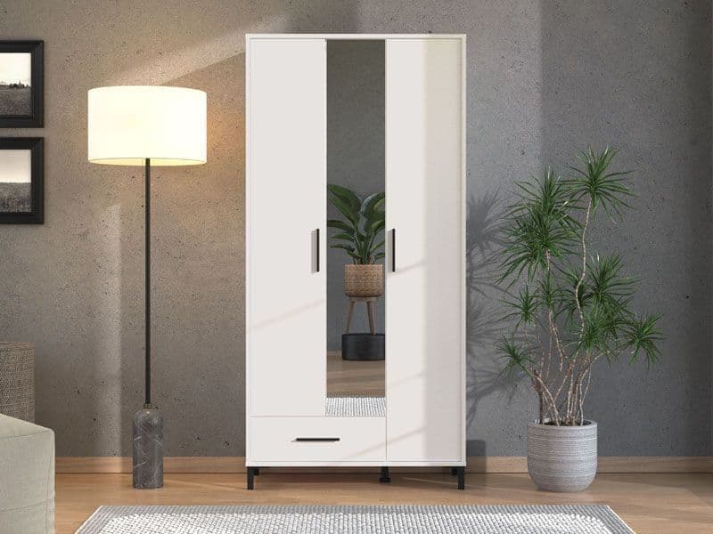 White wardrobe with mirror in a room with a lamp and plant