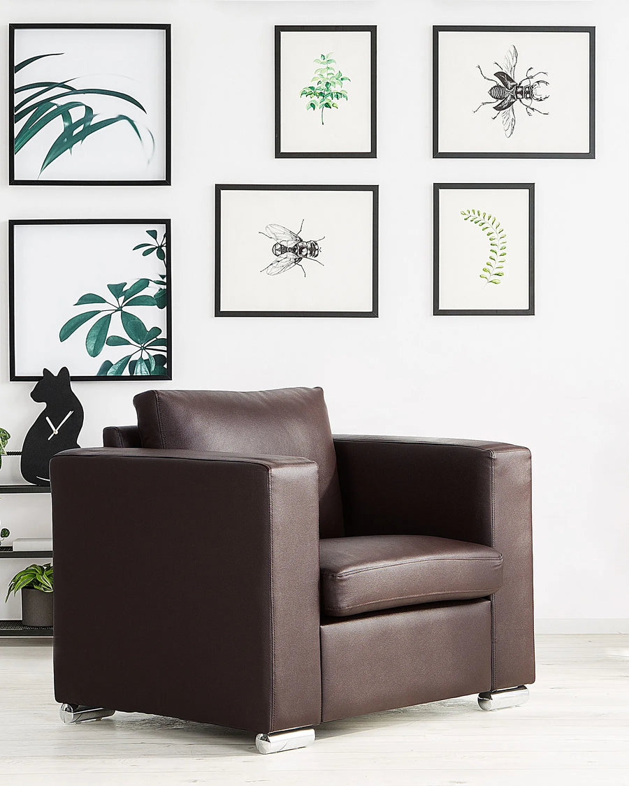 Brown armchair in a room with framed artwork on the wall.