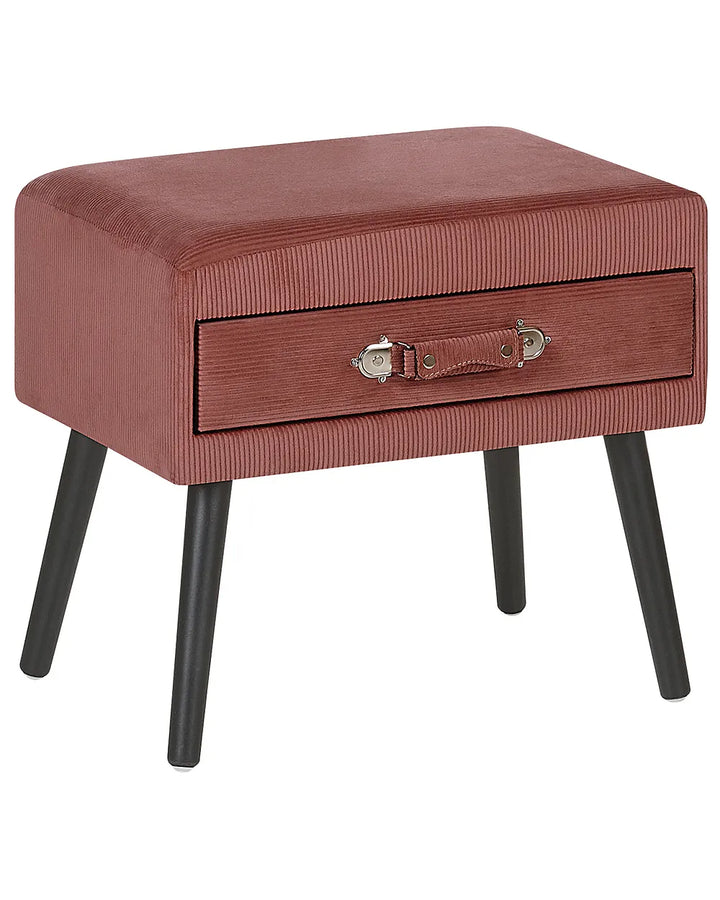 A rectangular upholstered ottoman or small bench with a single drawer, covered in a ribbed dusty rose pink fabric and supported by four black tapered legs. The drawer features a small stitched leather handle with a silver metal latch.