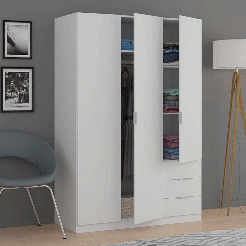 White wardrobe with open doors in a room with a chair, lamp, and framed pictures.