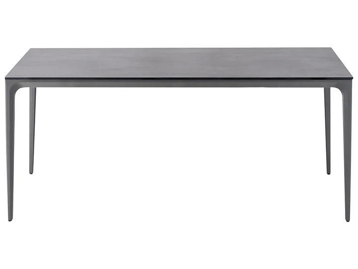 A dark gray rectangular dining table with slim, tapered legs, shown from a front angle on a solid white background.