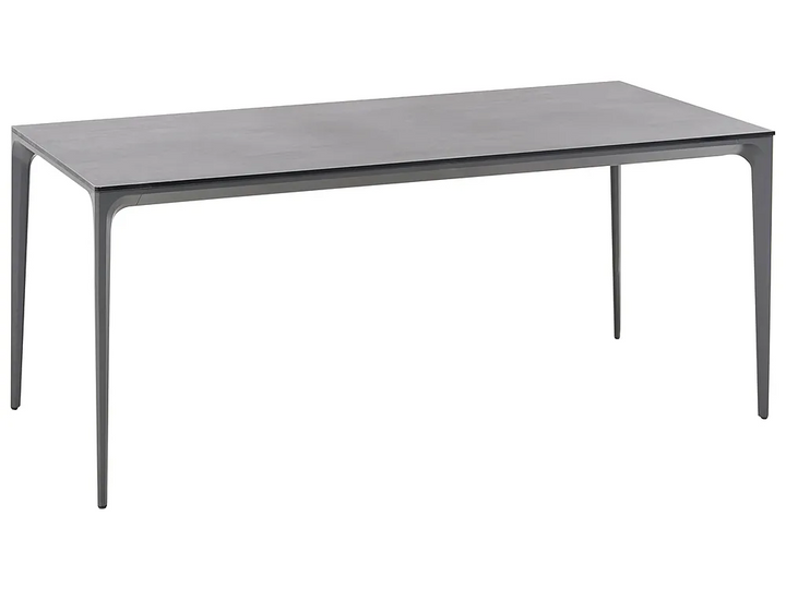 A modern rectangular dining table with a dark gray wood-grain top and slim, tapered metal legs, shown on a plain white background.