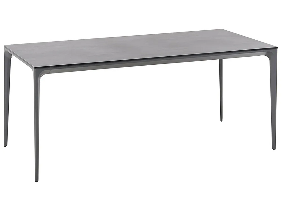 A modern rectangular dining table with a dark gray wood-grain top and slim, tapered metal legs, shown on a plain white background.