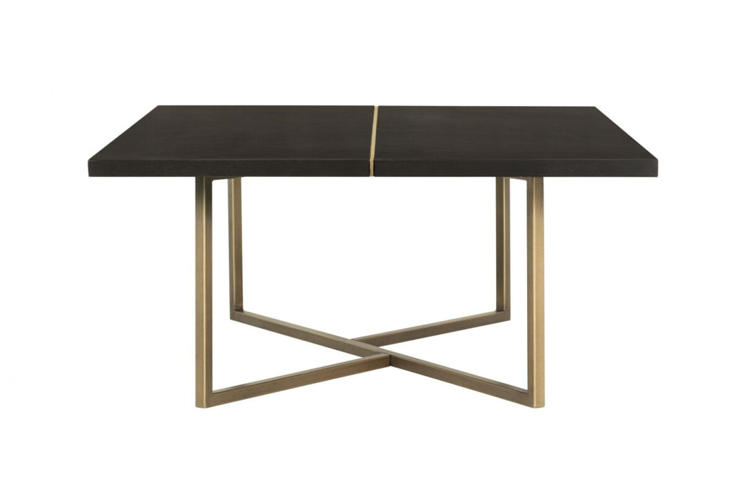 Dining table with black marble top and gold metal legs on a white background