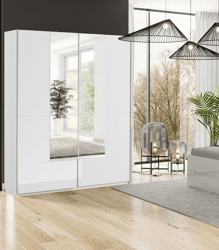 Modern interior design with a white wardrobe, glass doors, and a living area with plants and decor.