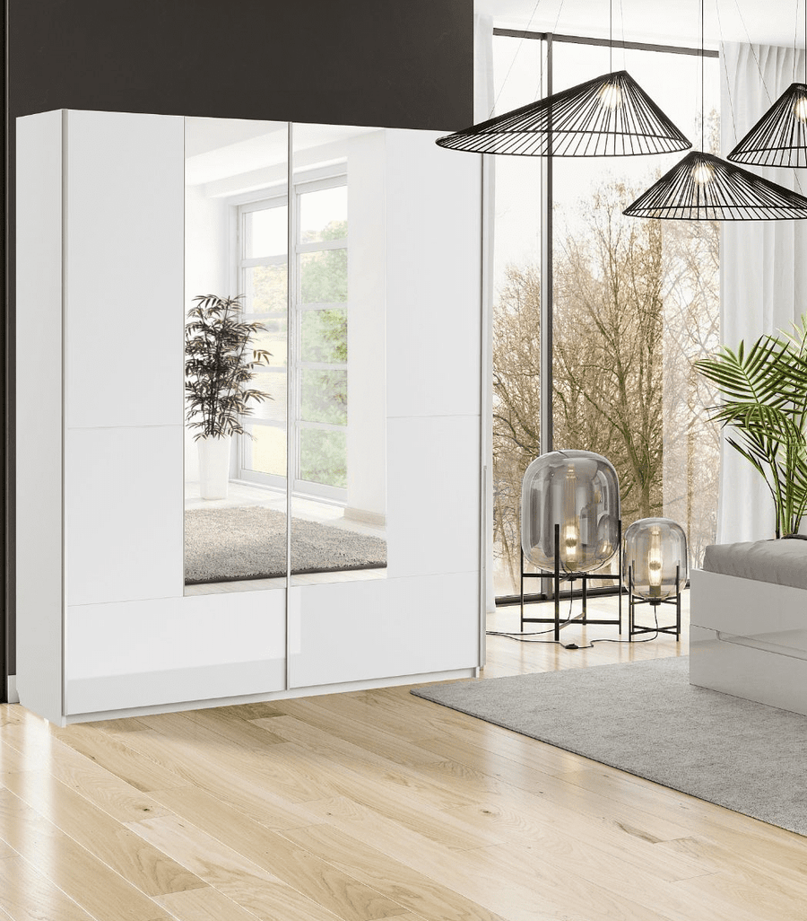 Modern interior design with a white wardrobe, glass doors, and a living area with plants and decor.