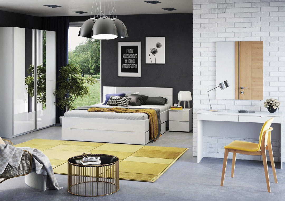 Modern bedroom with white bed, yellow accents, and a desk.