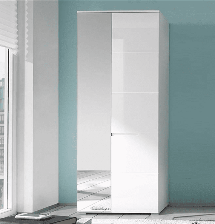 White wardrobe with mirror in a room with blue walls and a window.