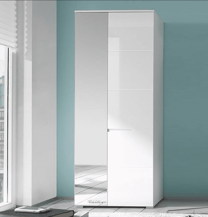 White wardrobe with mirror in a room with blue walls and a window.