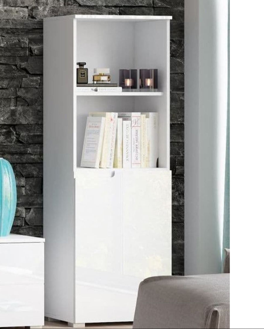 White bookshelf with books and decor items against a stone wall.