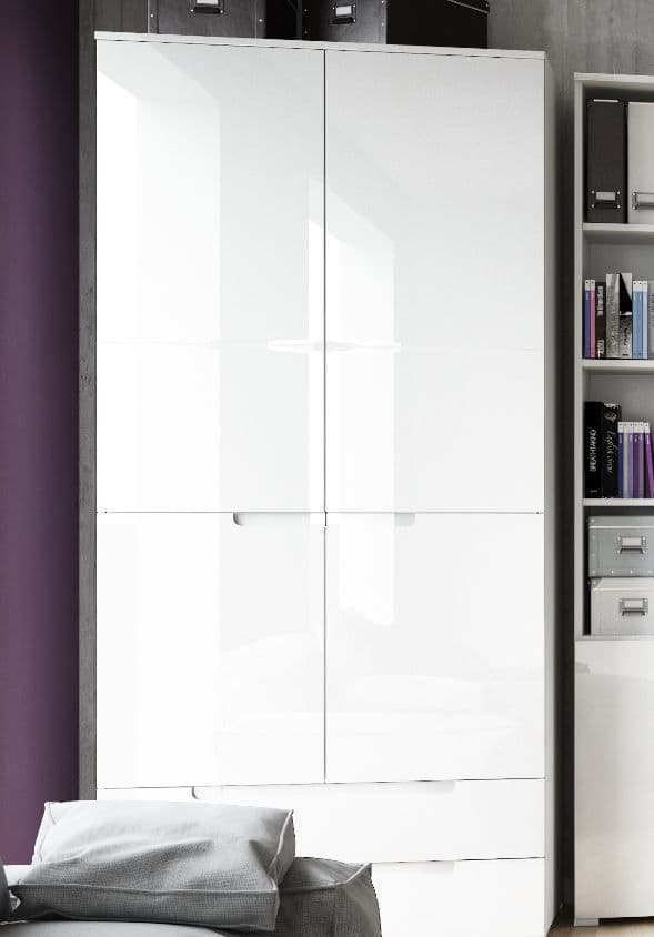 White wardrobe with a mirror in a room with a purple wall and shelves.