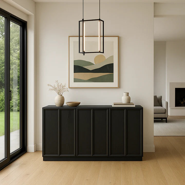 Modern interior with a black cabinet, decorative items, and a framed landscape painting.