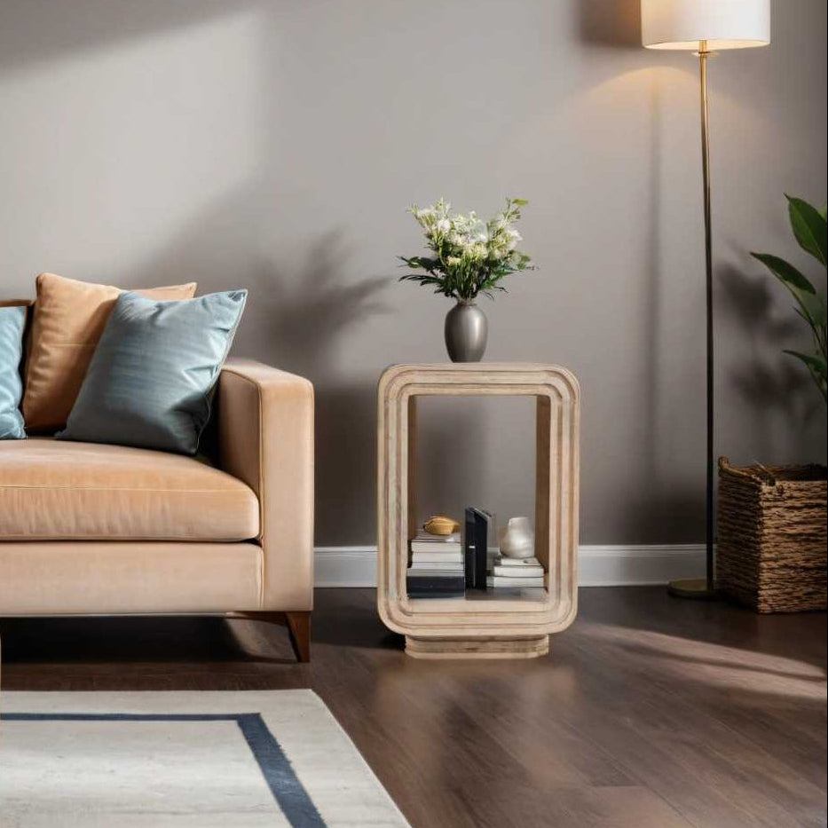 Modern living room with beige sofa, side table, and bookshelf.