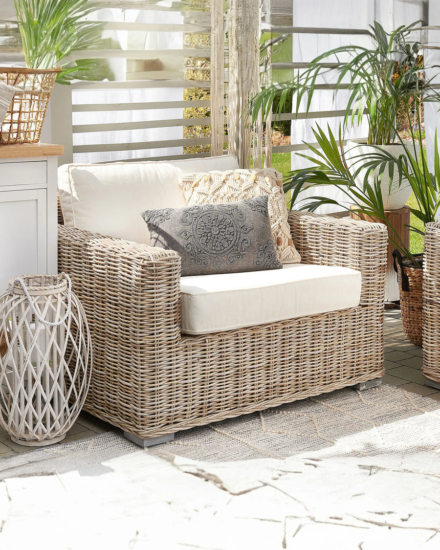 Wicker outdoor furniture set with cushions on a patio