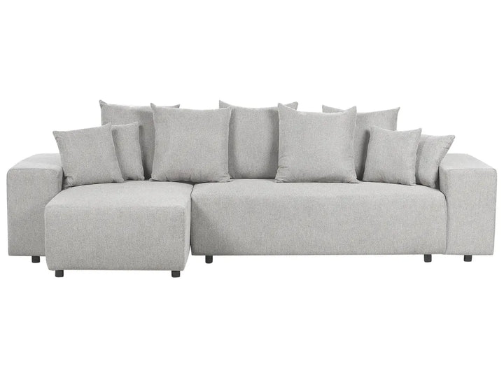 Gray sectional sofa with multiple cushions on a white background