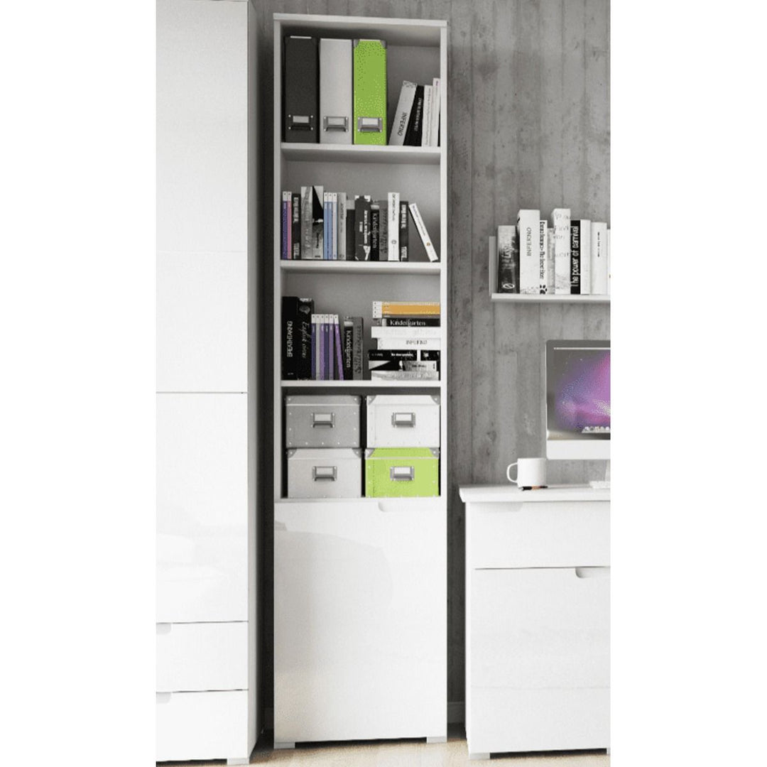 White bookshelf with books and storage boxes against a gray wall.