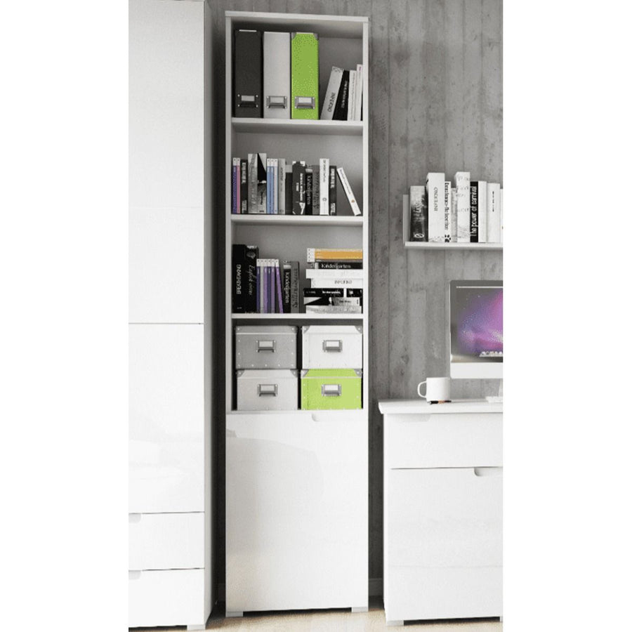 White bookshelf with books and storage boxes against a gray wall.