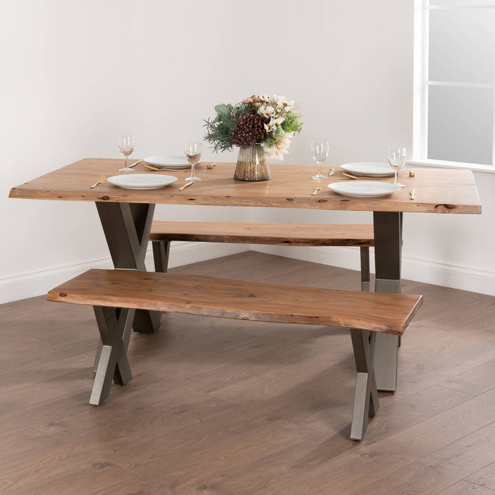 Wooden dining table with bench in a room with a window