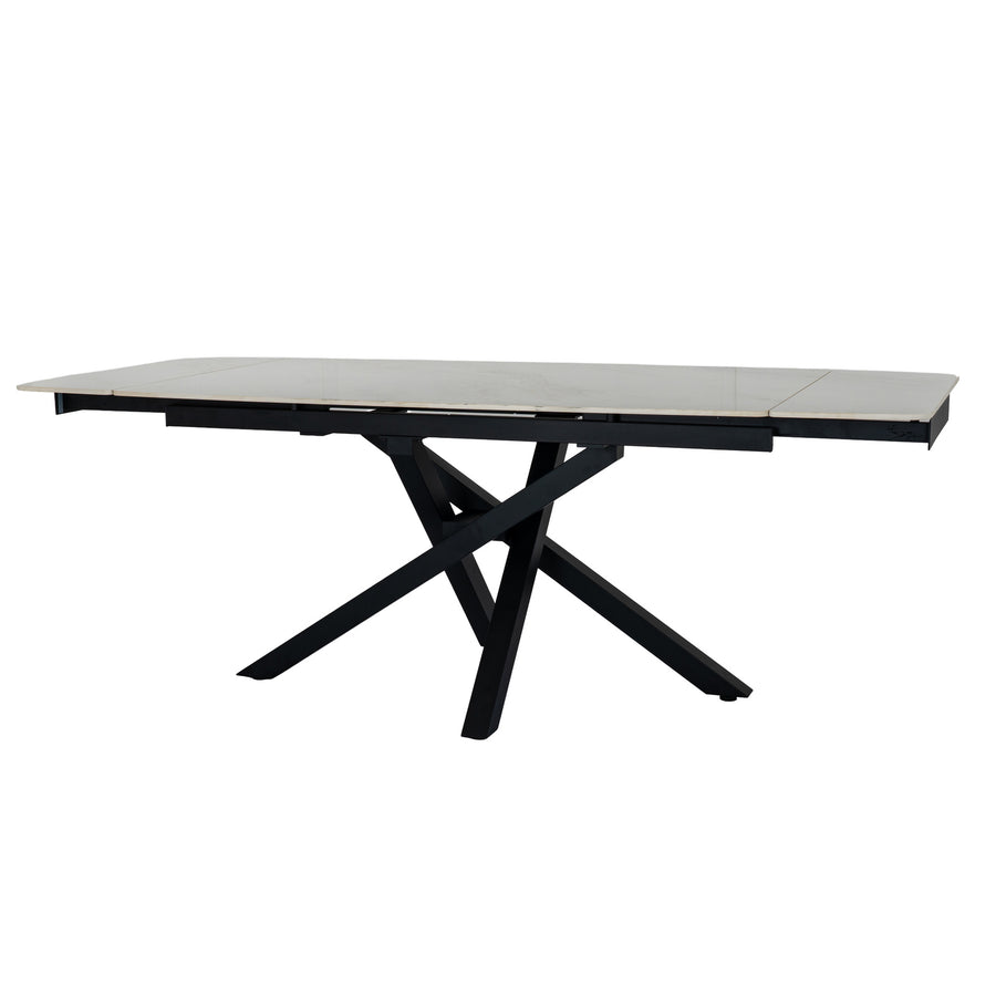 A modern rectangular dining table with a light gray stone or laminate top and a black metal extendable base, shown on a plain white background.