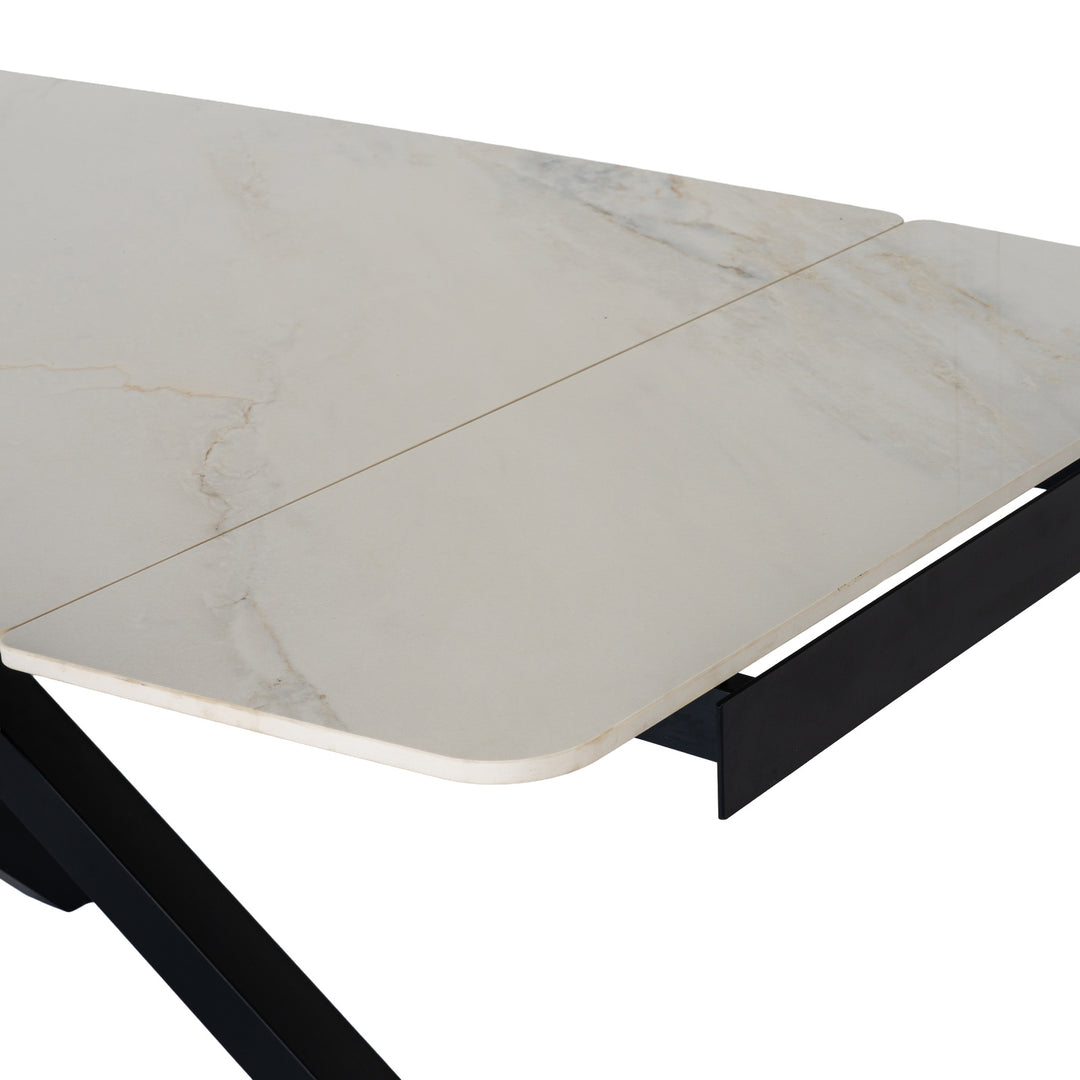 Close-up of a rectangular table with a white marble-look top featuring subtle gray veining and a black metal frame, shown on a white background.