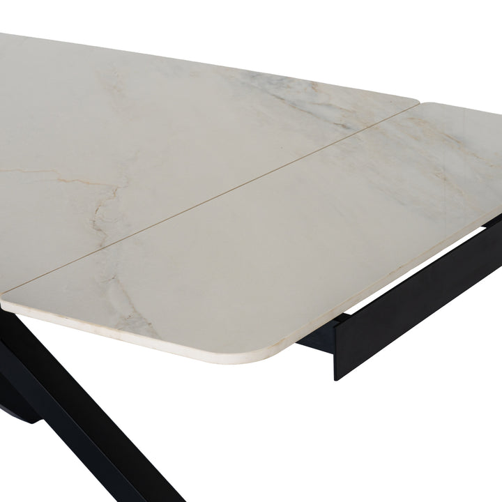 Close-up of a rectangular table with a white marble-look top featuring subtle gray veining and a black metal frame, shown on a white background.